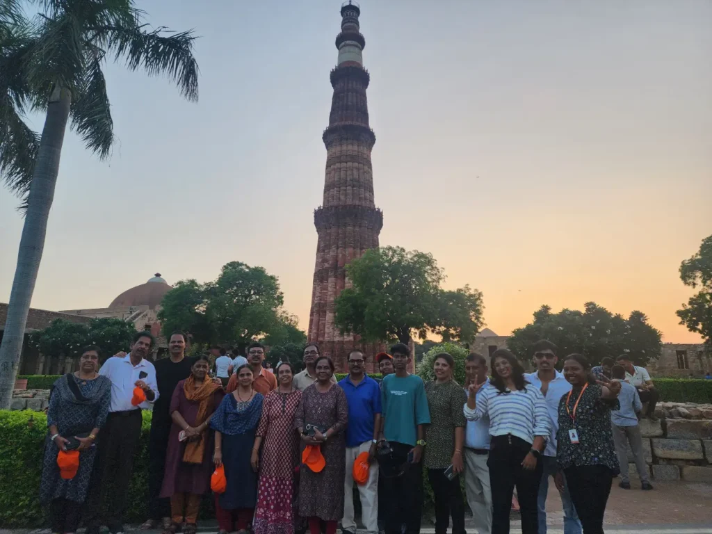 Tour group standing in front of Qutub Minar